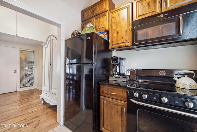 kitchen featuring light hardwood / wood-style flooring and black appliances