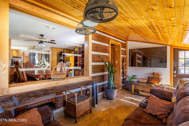 living room featuring wood walls, ceiling fan, and wooden ceiling