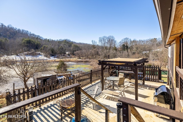 wooden terrace featuring an outdoor fire pit