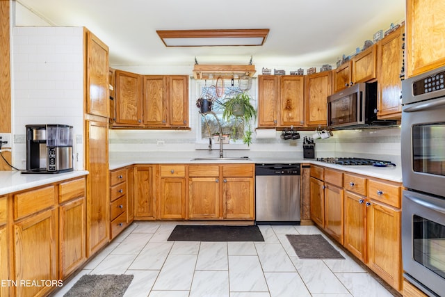 kitchen with decorative backsplash, sink, and appliances with stainless steel finishes