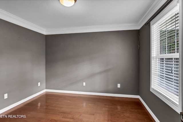 spare room with hardwood / wood-style floors and crown molding