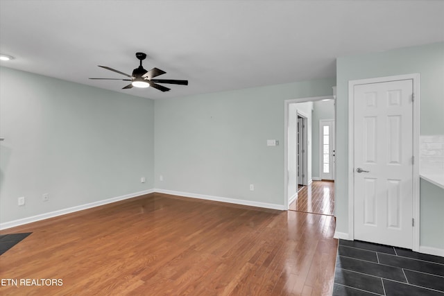 spare room with ceiling fan and dark hardwood / wood-style flooring