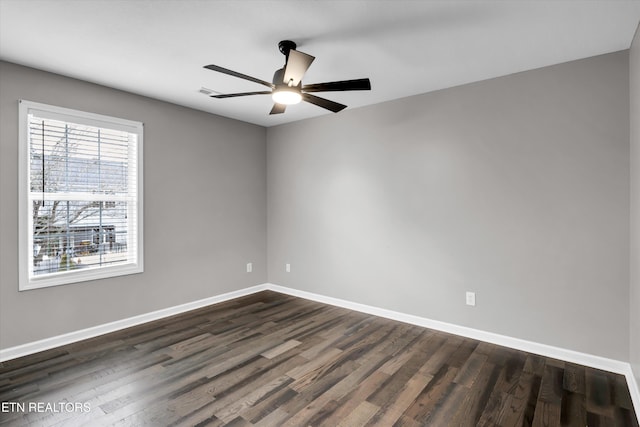 unfurnished room featuring ceiling fan and dark wood-type flooring