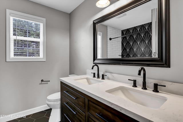 bathroom with tiled shower, tile patterned flooring, vanity, and toilet