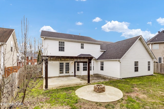 rear view of house with french doors, a patio, an outdoor fire pit, and a yard