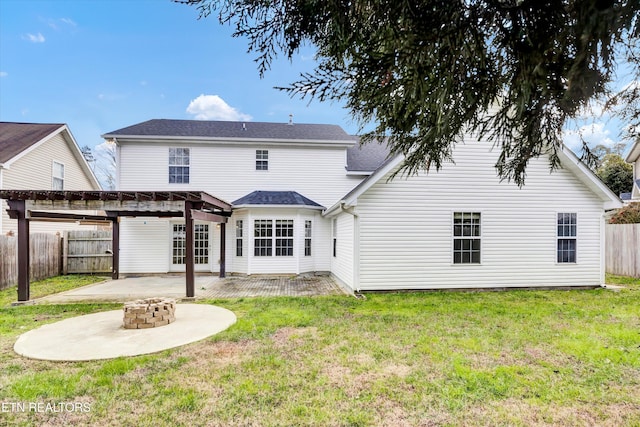 rear view of house featuring a lawn, a patio, and an outdoor fire pit