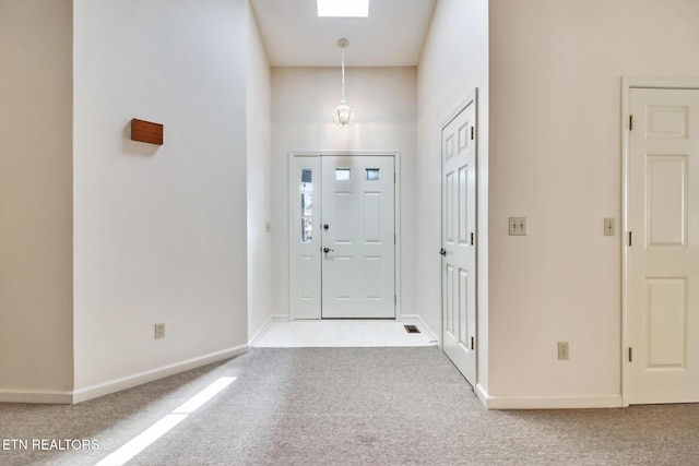 carpeted entryway with a skylight