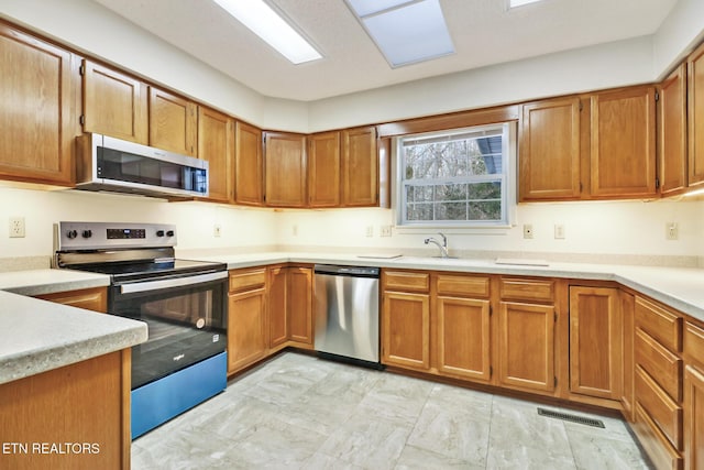 kitchen with a skylight and stainless steel appliances