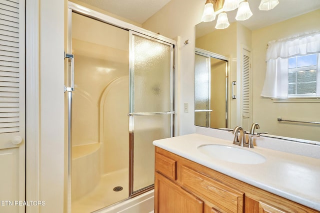 bathroom with vanity and a shower with shower door