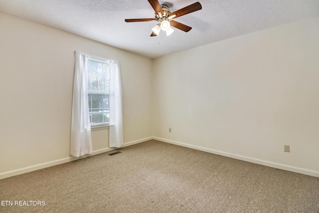 carpeted spare room with ceiling fan and a textured ceiling