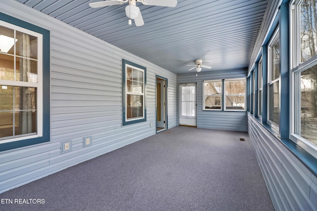 unfurnished sunroom featuring ceiling fan