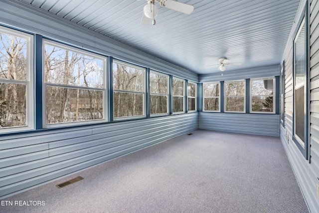 unfurnished sunroom with ceiling fan