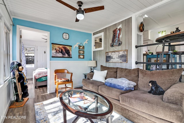 living room with a ceiling fan and wood finished floors