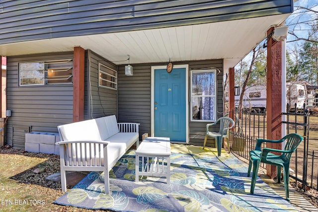 doorway to property with outdoor lounge area and fence