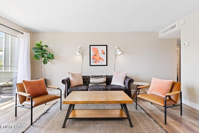 living room with light hardwood / wood-style flooring