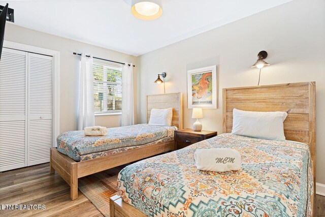 bedroom featuring hardwood / wood-style floors and a closet