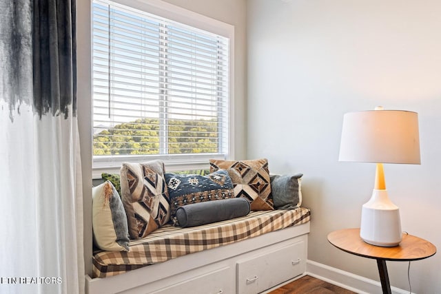 sitting room with plenty of natural light and dark hardwood / wood-style floors