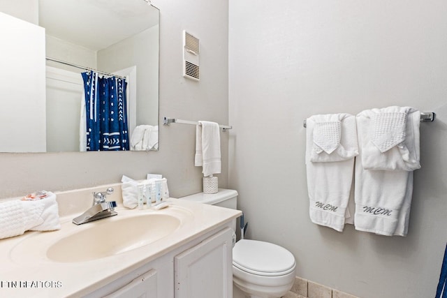 bathroom with vanity, toilet, and walk in shower