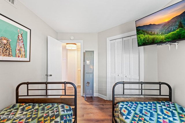 bedroom with hardwood / wood-style floors and a closet