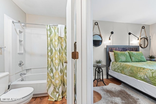 bathroom with toilet, wood-type flooring, and shower / tub combo with curtain