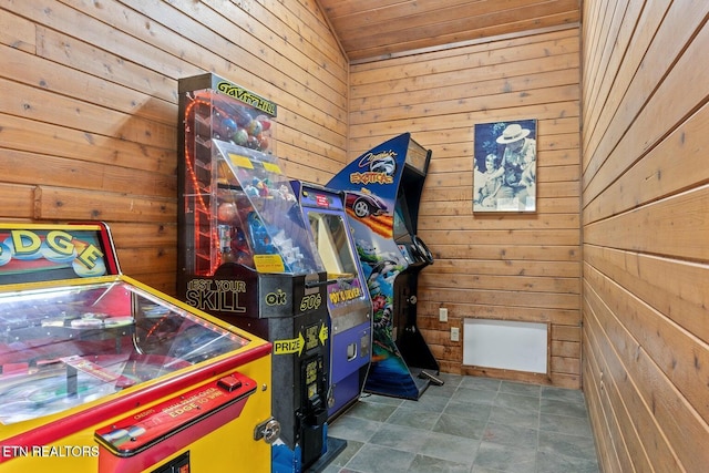 rec room featuring wood ceiling and wooden walls