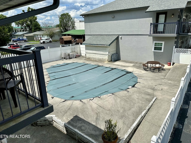 view of swimming pool with a patio area and a fire pit