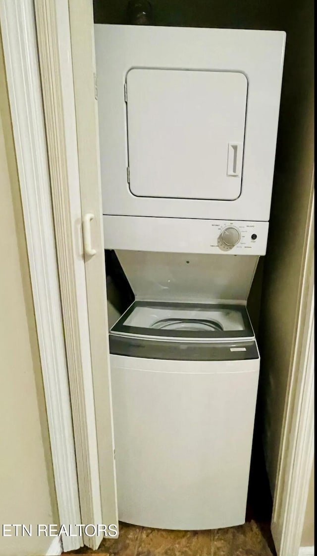 laundry area featuring stacked washing maching and dryer