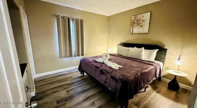 bedroom with hardwood / wood-style floors