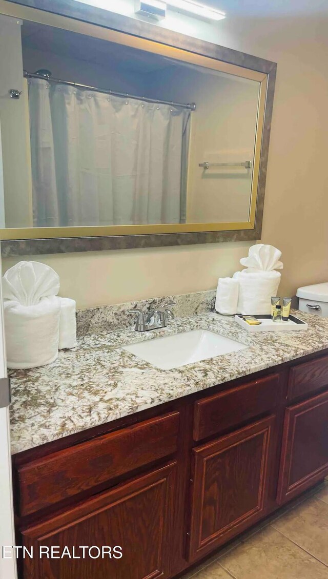 bathroom with tile patterned flooring and vanity