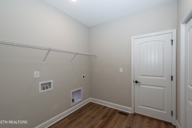 laundry room with laundry area, baseboards, visible vents, wood finished floors, and electric dryer hookup