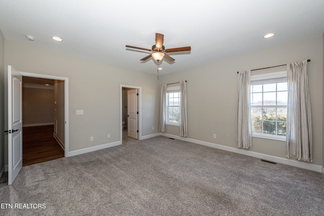 unfurnished bedroom with carpet floors, recessed lighting, visible vents, and baseboards