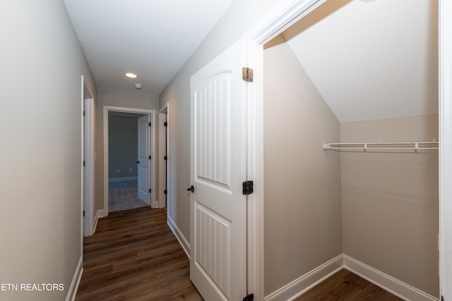 corridor with baseboards, dark wood-type flooring, and recessed lighting