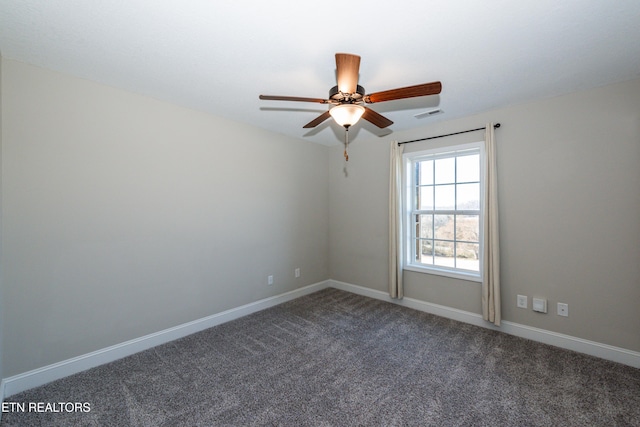 carpeted spare room with ceiling fan, visible vents, and baseboards