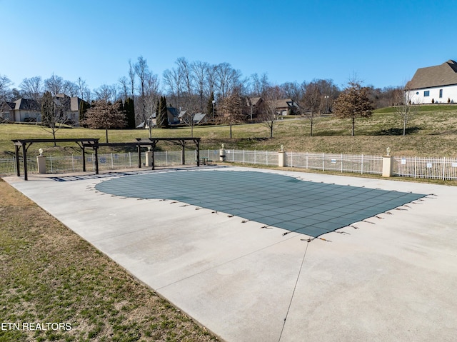 community pool featuring fence, a lawn, and a patio