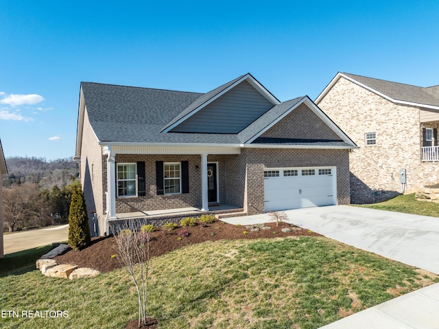 view of front of house featuring brick siding, a porch, an attached garage, driveway, and a front lawn