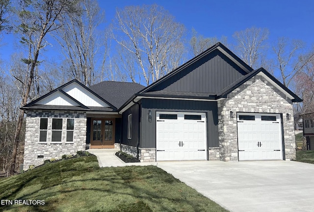 view of front of house with french doors, a front lawn, and a garage