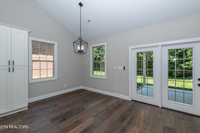 unfurnished dining area with baseboards, a chandelier, dark wood-style floors, visible vents, and lofted ceiling