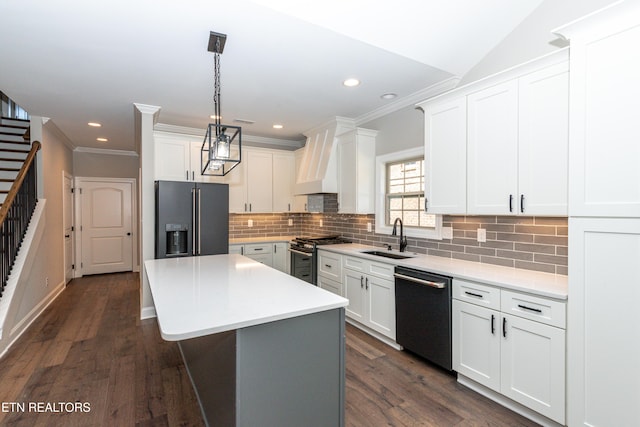 kitchen featuring tasteful backsplash, black fridge, gas range, a sink, and dishwashing machine