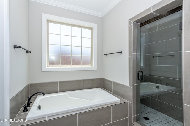 bathroom featuring ornamental molding, a stall shower, and a garden tub