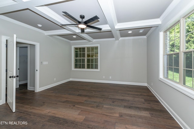 spare room featuring a wealth of natural light, crown molding, beam ceiling, and coffered ceiling