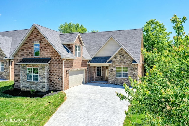 craftsman house featuring stone siding, decorative driveway, a front lawn, an attached garage, and a shingled roof