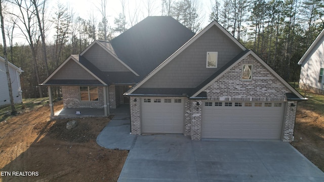 craftsman house with covered porch and a garage