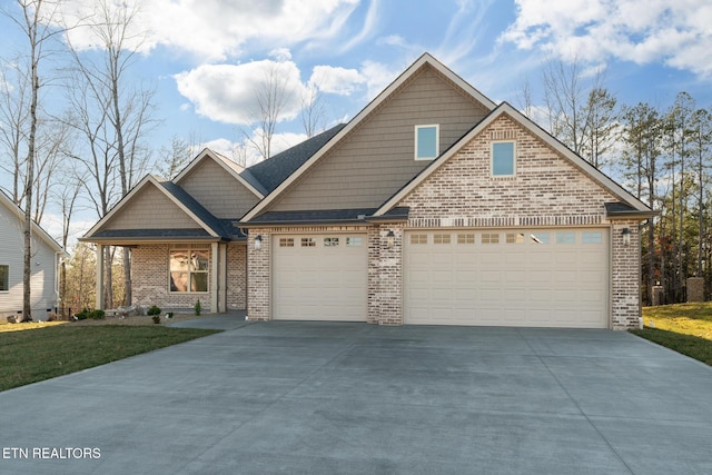 craftsman-style house with a garage, concrete driveway, and brick siding