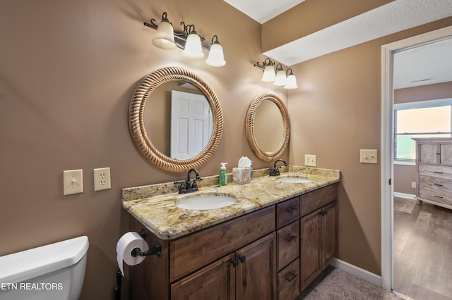 bathroom with vanity and toilet