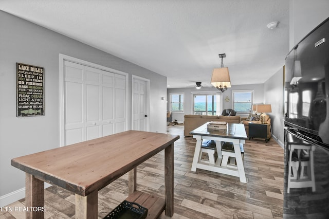 dining area featuring ceiling fan and a textured ceiling