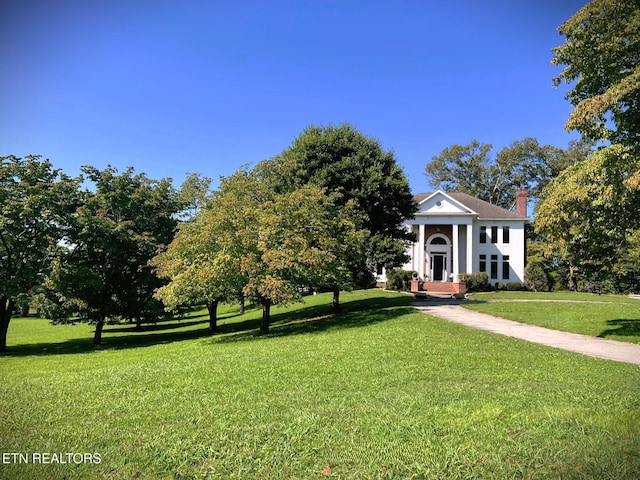 neoclassical / greek revival house with a front lawn