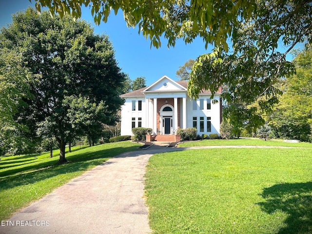 neoclassical home with a front yard