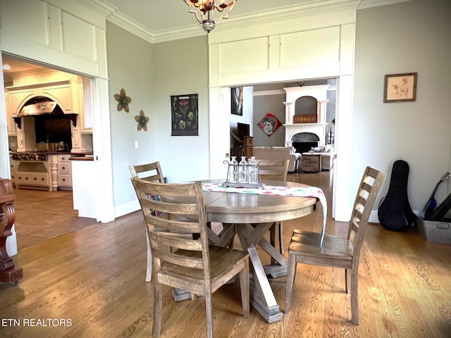 dining room featuring hardwood / wood-style flooring and ornamental molding