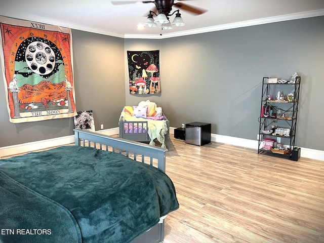 bedroom with crown molding, wood-type flooring, and ceiling fan