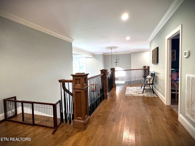 hallway featuring ornamental molding and hardwood / wood-style floors